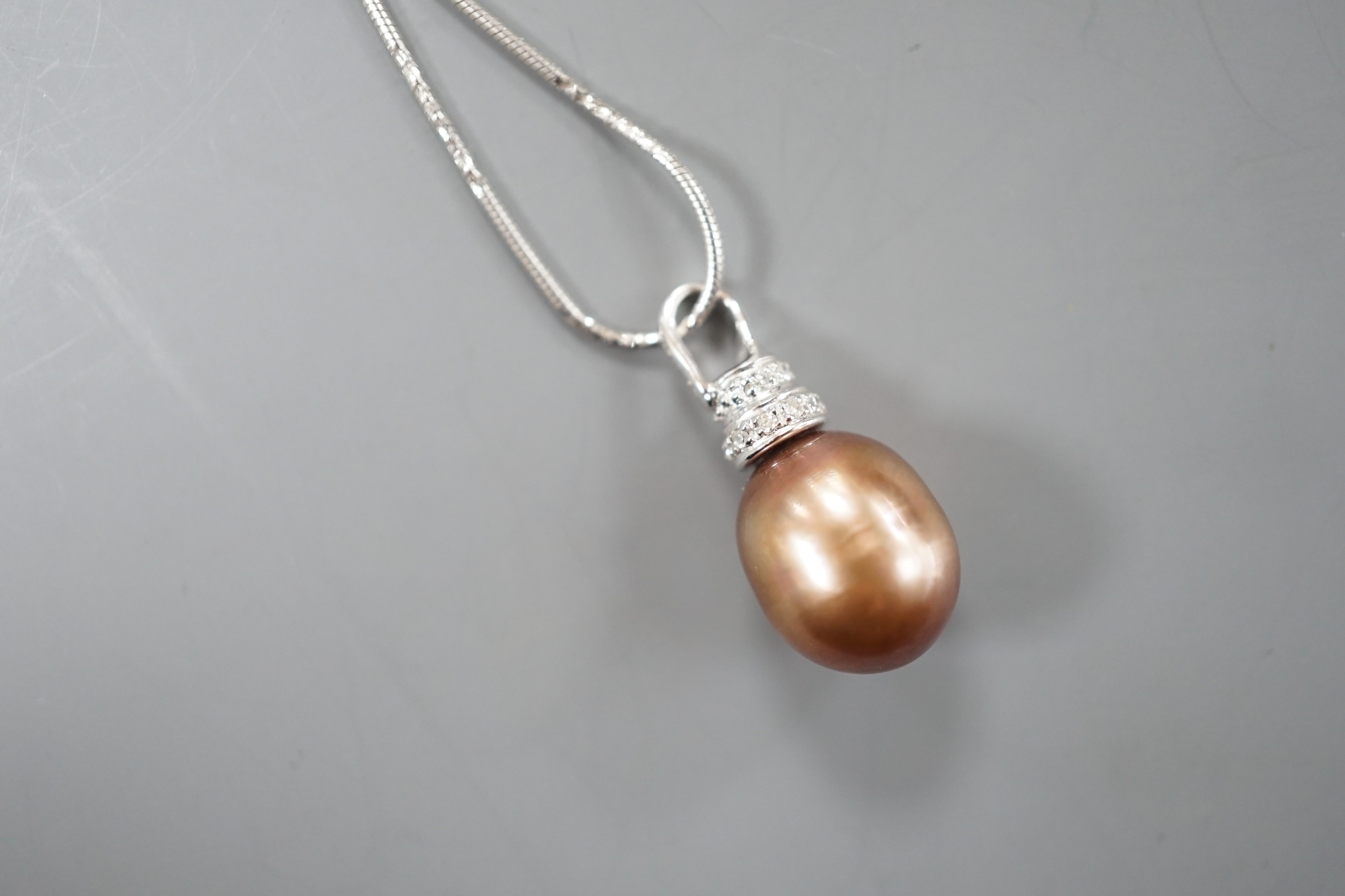 A modern 750 white metal South Sea culture pearl and diamond chip set pendant necklace, overall 48cm, gross weight 7.2 grams.